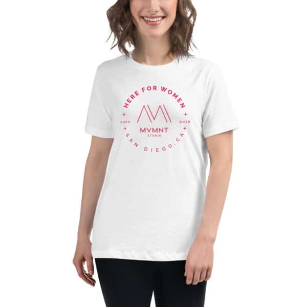 A woman wearing a white t-shirt with the "Here For Women" logo from MVMNT Studio.